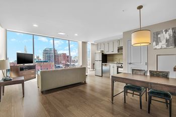 a living room and kitchen with a view of the city